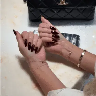 Manicure with blackberry-colored nail polish.