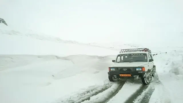 Manali: A vehicle seen stranded in a snow-covered street after heavy snowfall at Rohtang Pass, in Manali, on May 1, 2019. (Photo: IANS)