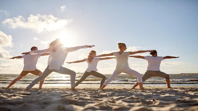 Utthita Trikonasana | The "triangle pose" involves positioning your feet wide apart and rotating one foot outward. Inhale while lifting both arms parallel to the floor and exhale while lowering one arm to touch the ground near the outward-facing foot.