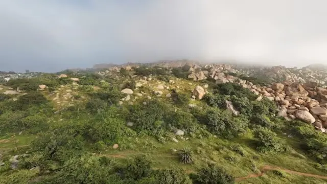 No 1. Antara Gange | A fantastic monsoon getaway for trekking fans, Antara Gange is situated just 70 km from Bengaluru. Located in Kolar district, Karnataka, it's known for its captivating natural caves that attract thrill-seekers and nature lovers alike. The stunning greenery and clouds beneath create an experience akin to visiting another world.