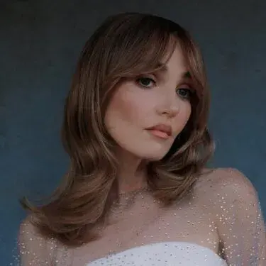 soft curtain bangs on Chloe Fineman