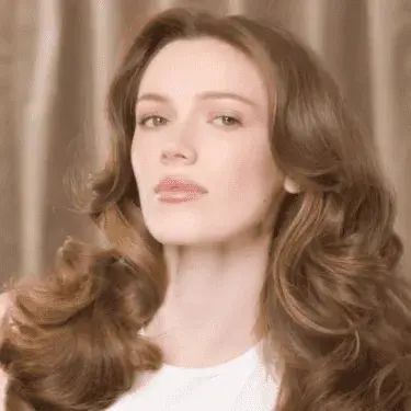 Voluminous blowout hairstyle with big curls