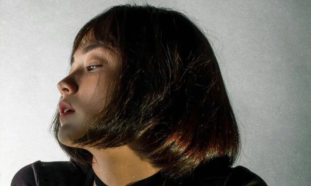 woman with blunt bob looking to the side